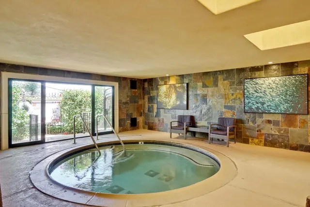 a view of a swimming pool with outdoor seating