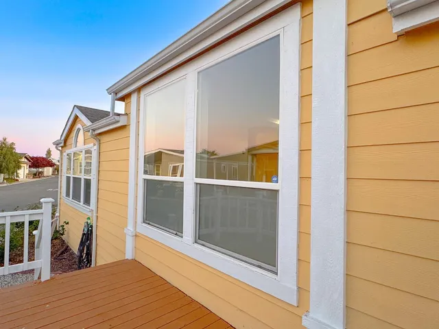 a view of a balcony with wooden floor and iron stairs
