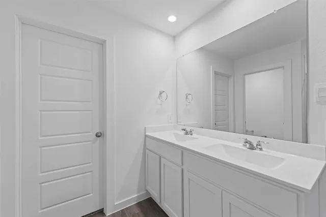 a bathroom with a double vanity sink and mirror