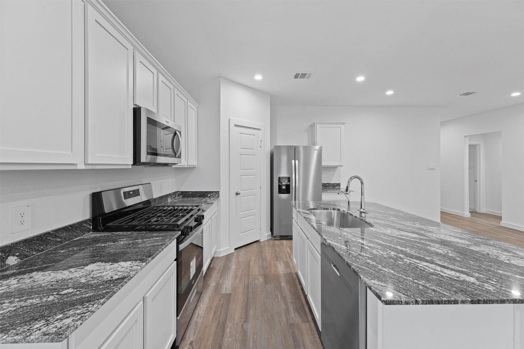 1115 Briscoe Court Rosharon, TX 77583 - Photo 8 of 16 a kitchen with stainless steel appliances granite countertop a sink stove and refrigerator