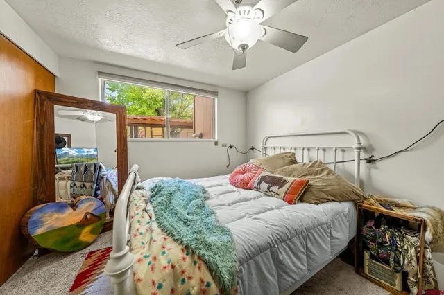a bedroom with a bed and ceiling fan