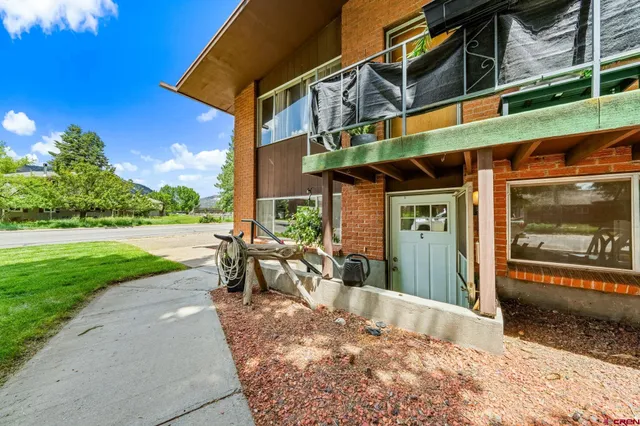 an aerial view of residential houses with outdoor space and street view
