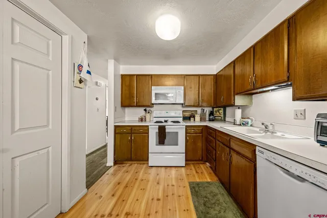 a kitchen with stainless steel appliances a refrigerator and a stove