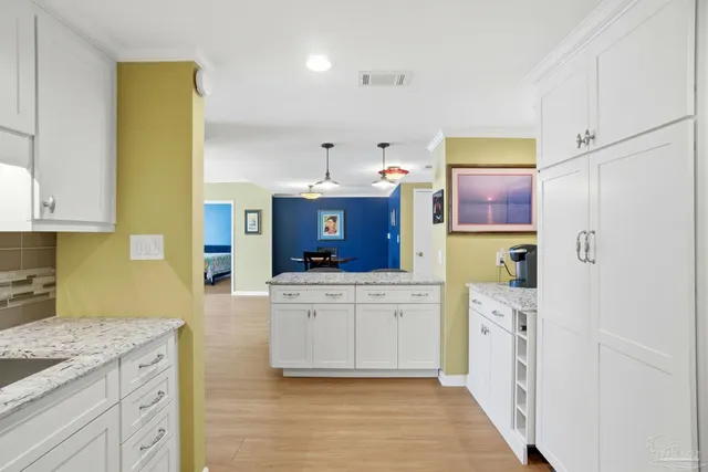a kitchen with stainless steel appliances a refrigerator sink and cabinets