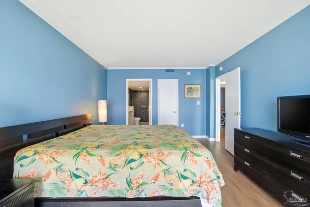 a bedroom with a bed and a flat screen tv