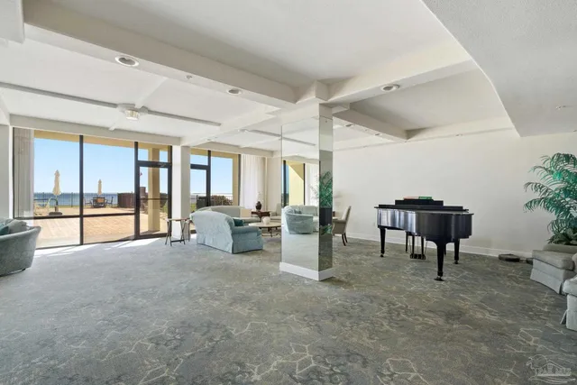 a living room with furniture and wooden table