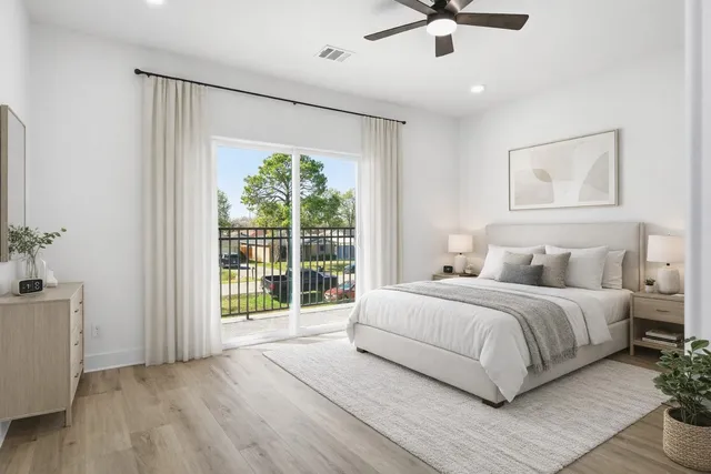 a spacious bedroom with a large bed and a chandelier