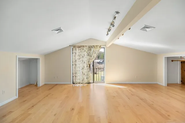 a view of empty room with wooden ceiling