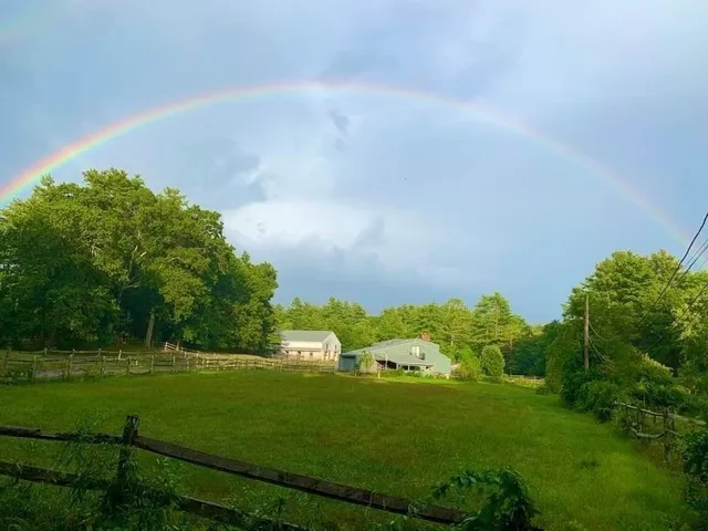 a view of a house with a yard and sitting area