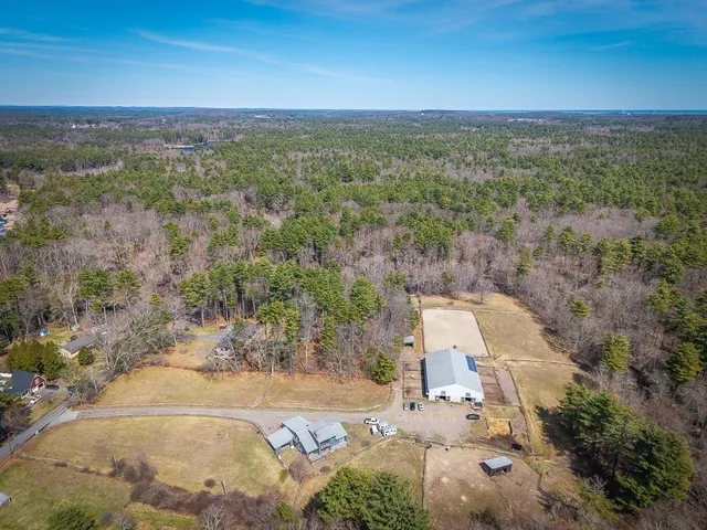 a backyard of a house with barbeque oven and outdoor seating