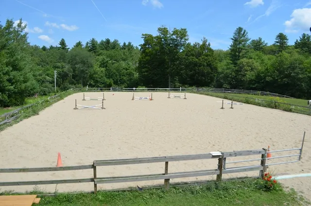 a view of backyard with wooden fence