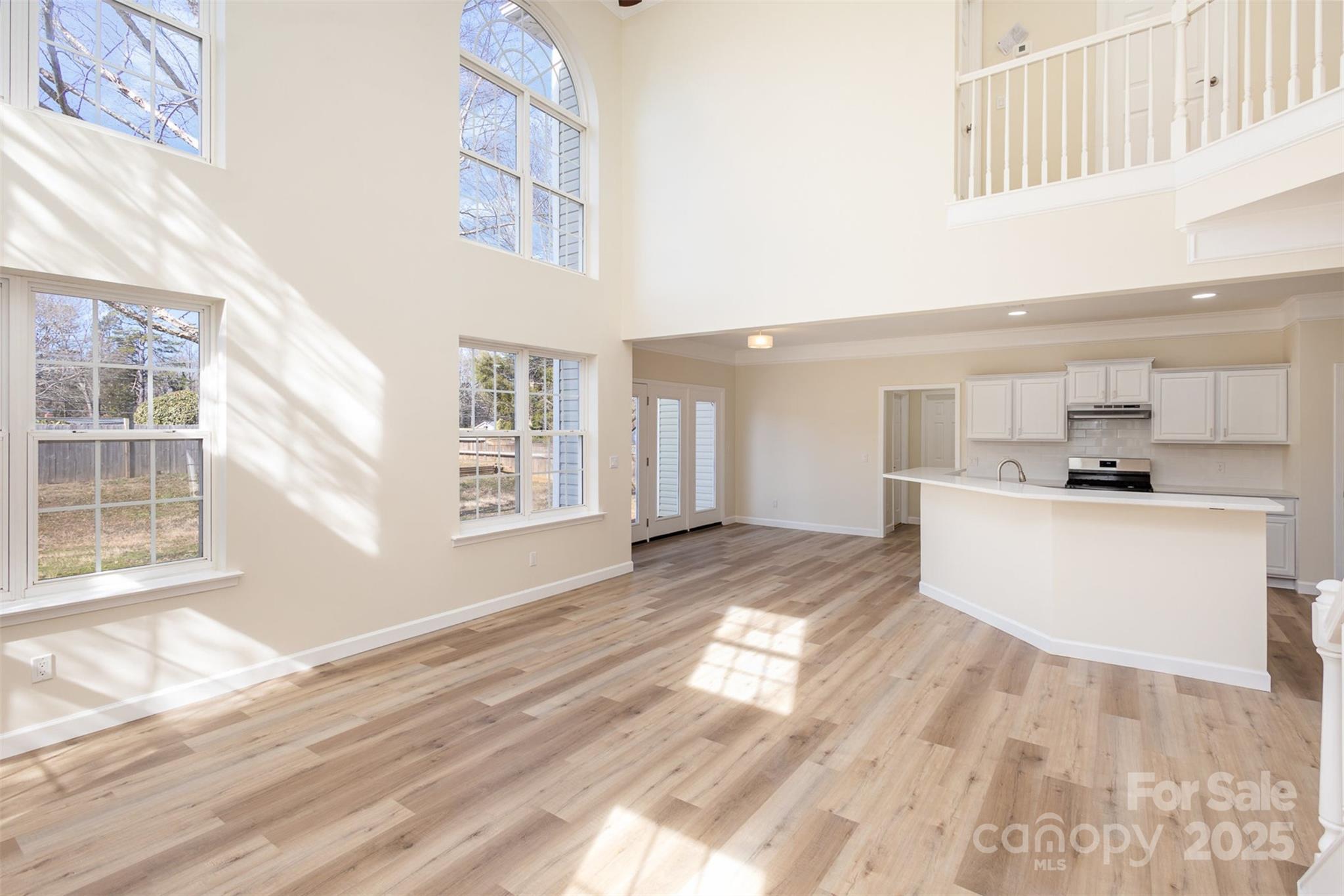 132 Elizabeth Hearth Road Mooresville, NC 28115 - Photo 11 of 40 a view of kitchen with kitchen island microwave and wooden floor
