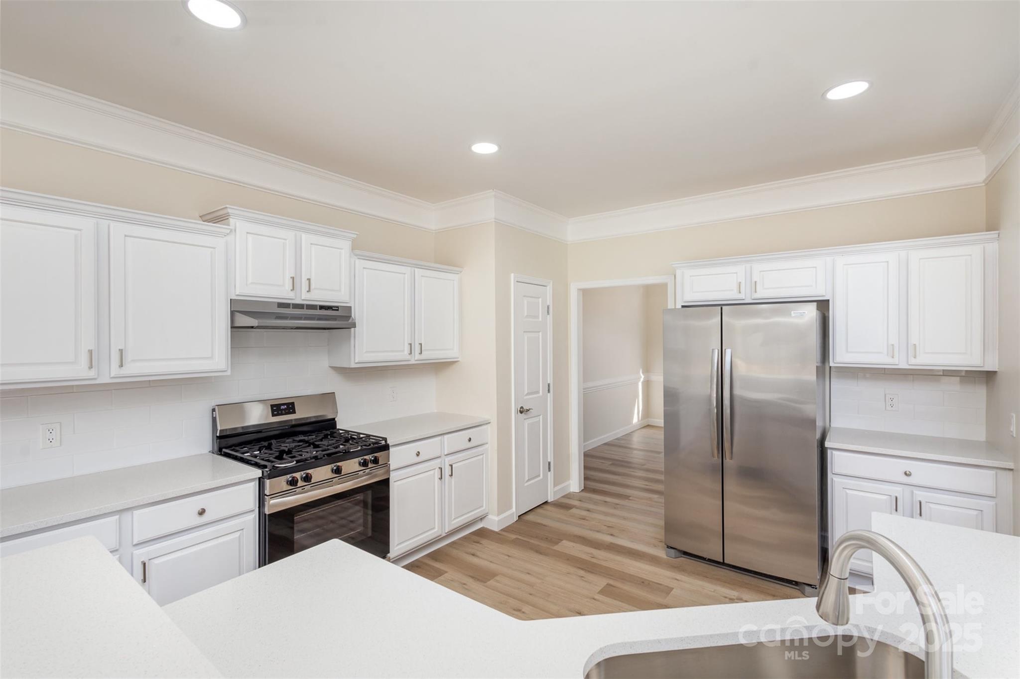 132 Elizabeth Hearth Road Mooresville, NC 28115 - Photo 14 of 40 a kitchen with stainless steel appliances granite countertop a refrigerator sink and stove