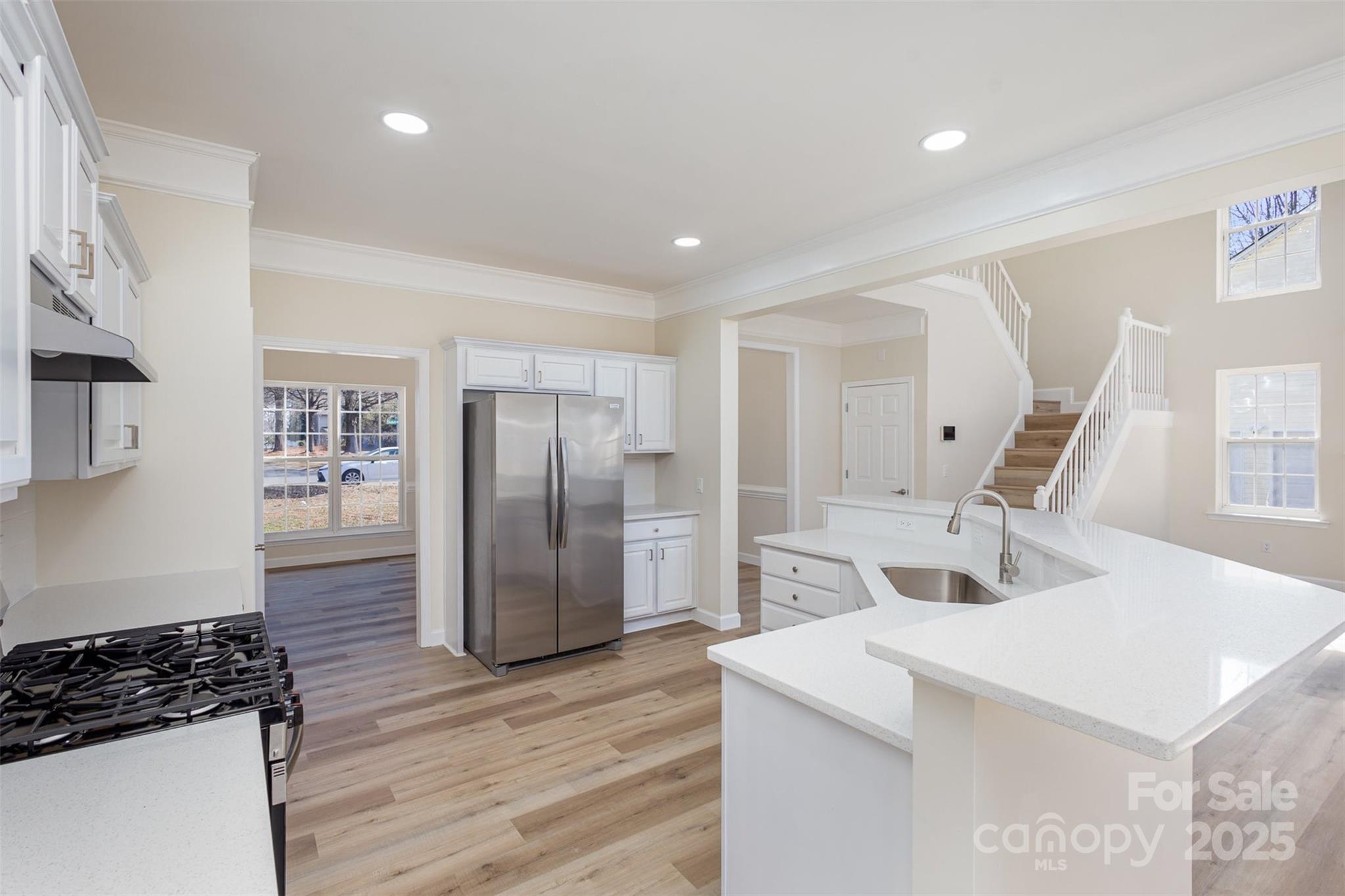132 Elizabeth Hearth Road Mooresville, NC 28115 - Photo 15 of 40 a kitchen with stainless steel appliances a refrigerator and a stove top oven
