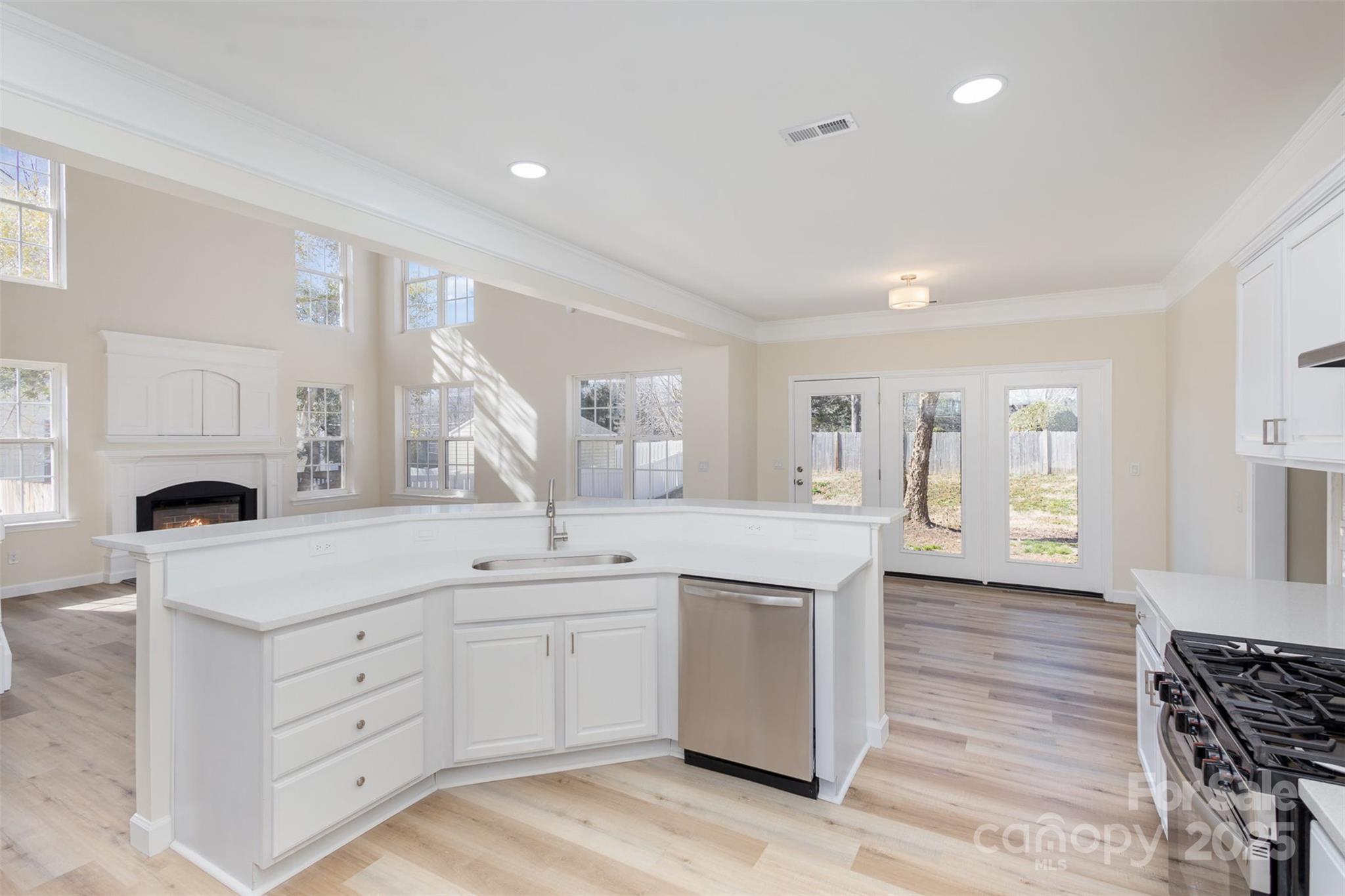 132 Elizabeth Hearth Road Mooresville, NC 28115 - Photo 16 of 40 a kitchen with a sink cabinets and wooden floor