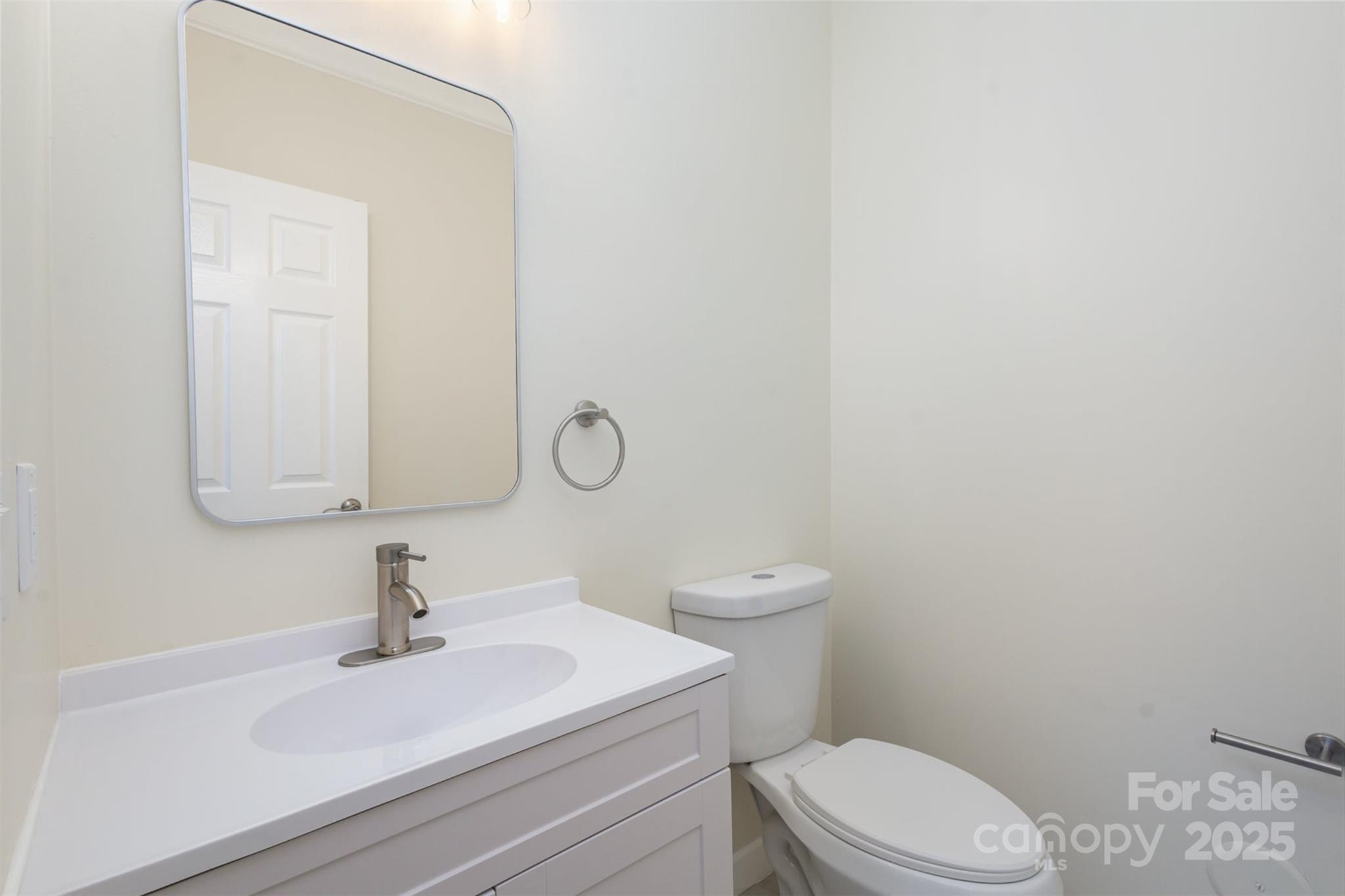 132 Elizabeth Hearth Road Mooresville, NC 28115 - Photo 20 of 40 a bathroom with a sink a toilet and mirror