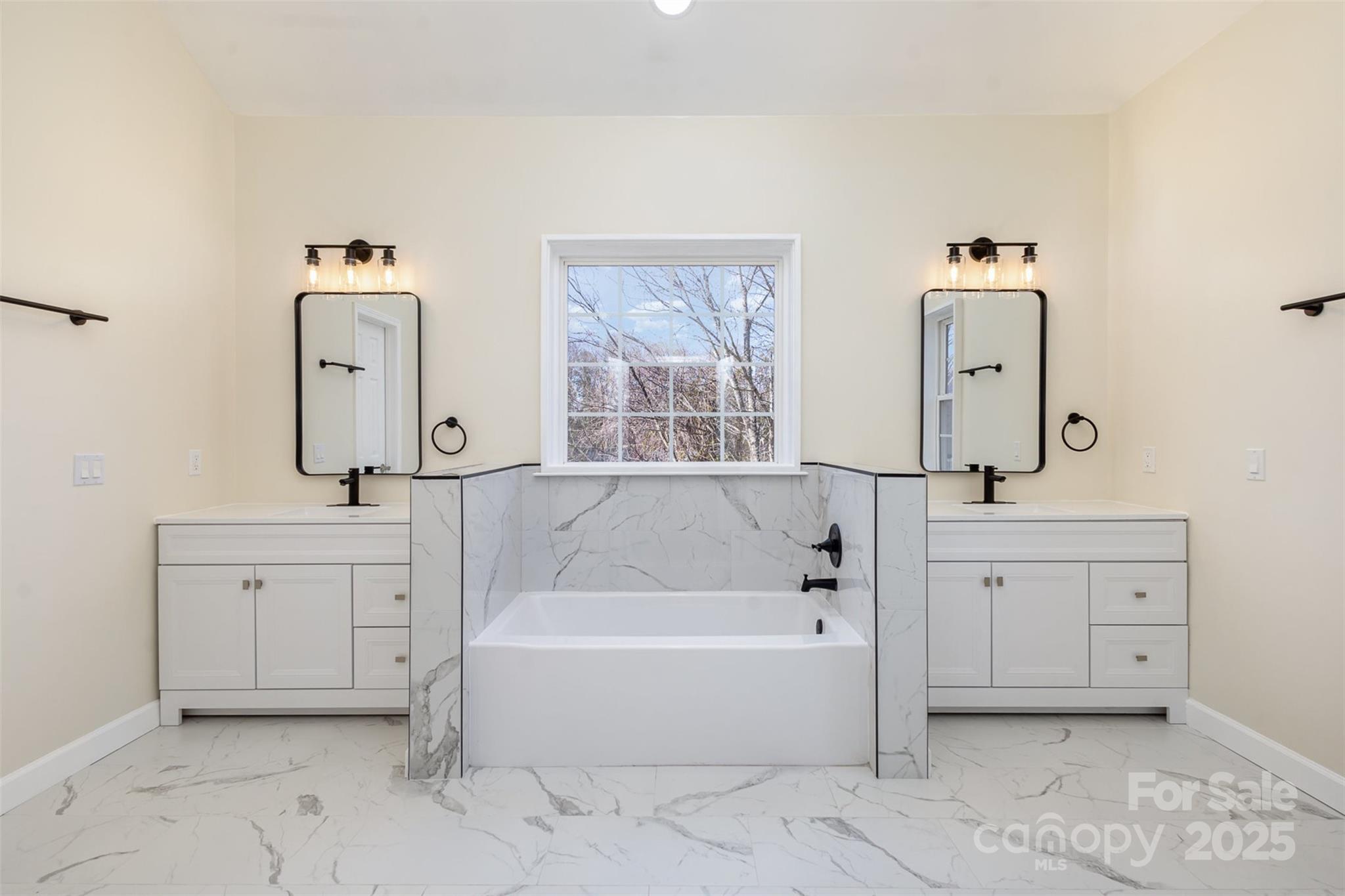 132 Elizabeth Hearth Road Mooresville, NC 28115 - Photo 25 of 40 a bathroom with a bathtub sink and mirror