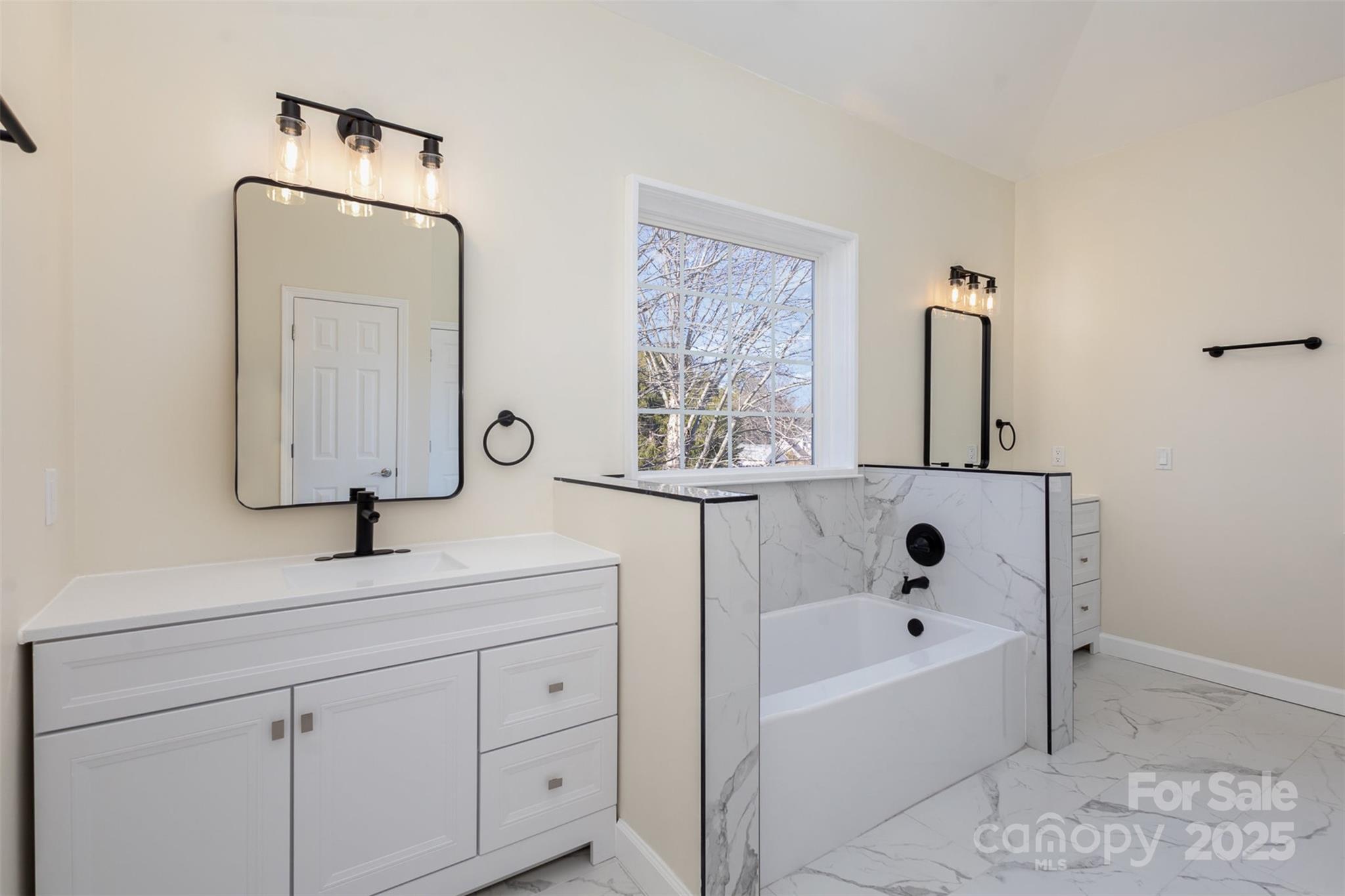 132 Elizabeth Hearth Road Mooresville, NC 28115 - Photo 26 of 40 a bathroom with a tub sink and mirror