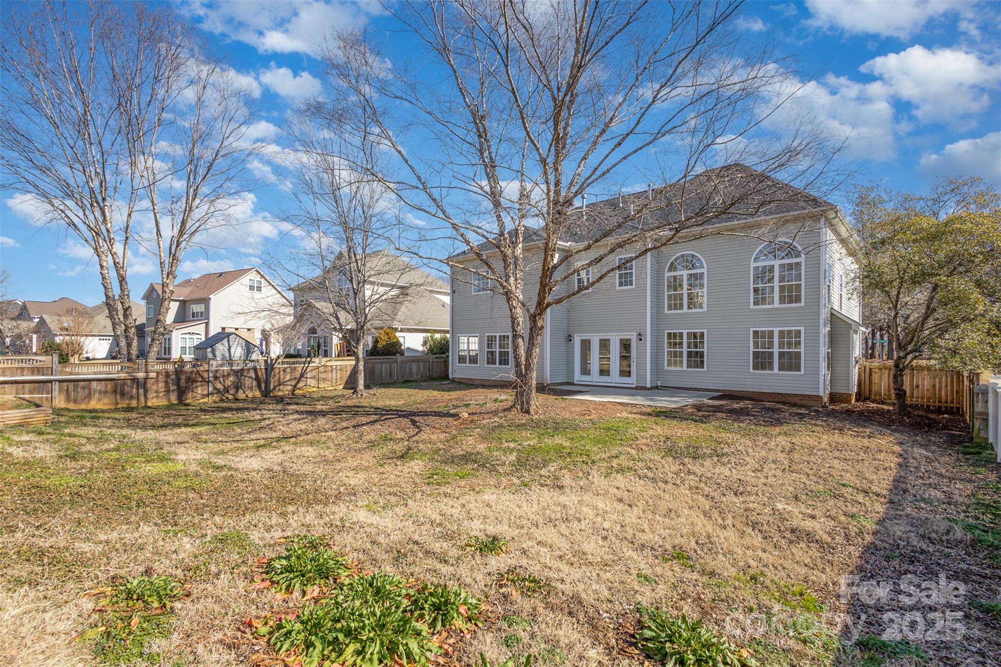 132 Elizabeth Hearth Road Mooresville, NC 28115 - Photo 35 of 40 a view of a white house with a yard covered with snow