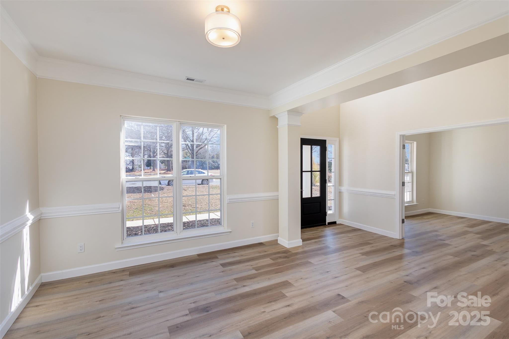 132 Elizabeth Hearth Road Mooresville, NC 28115 - Photo 6 of 40 an empty room with wooden floor and windows