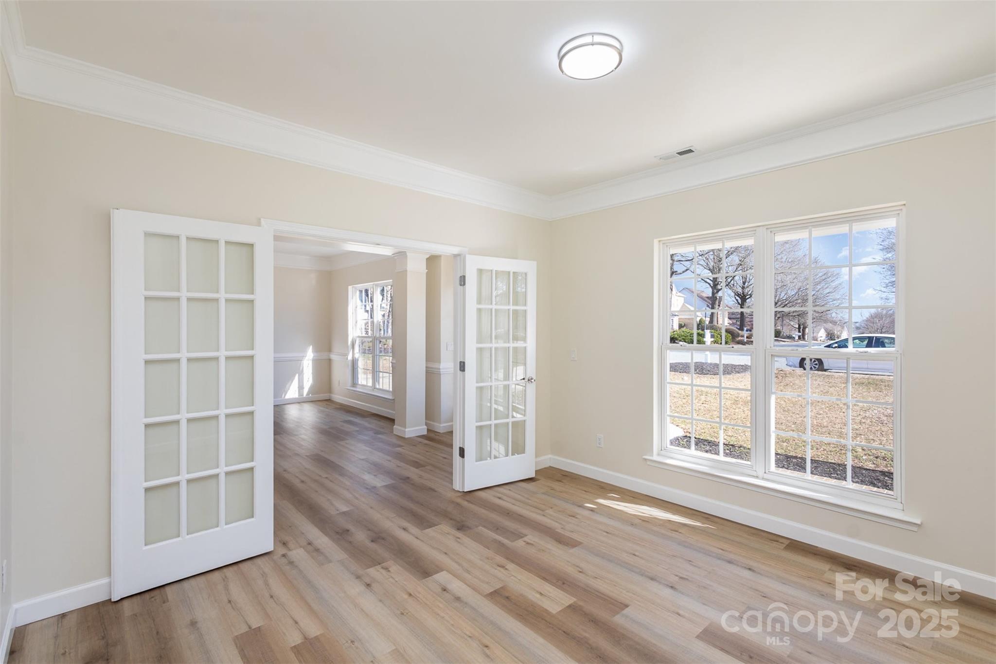 132 Elizabeth Hearth Road Mooresville, NC 28115 - Photo 7 of 40 an empty room with wooden floor and windows