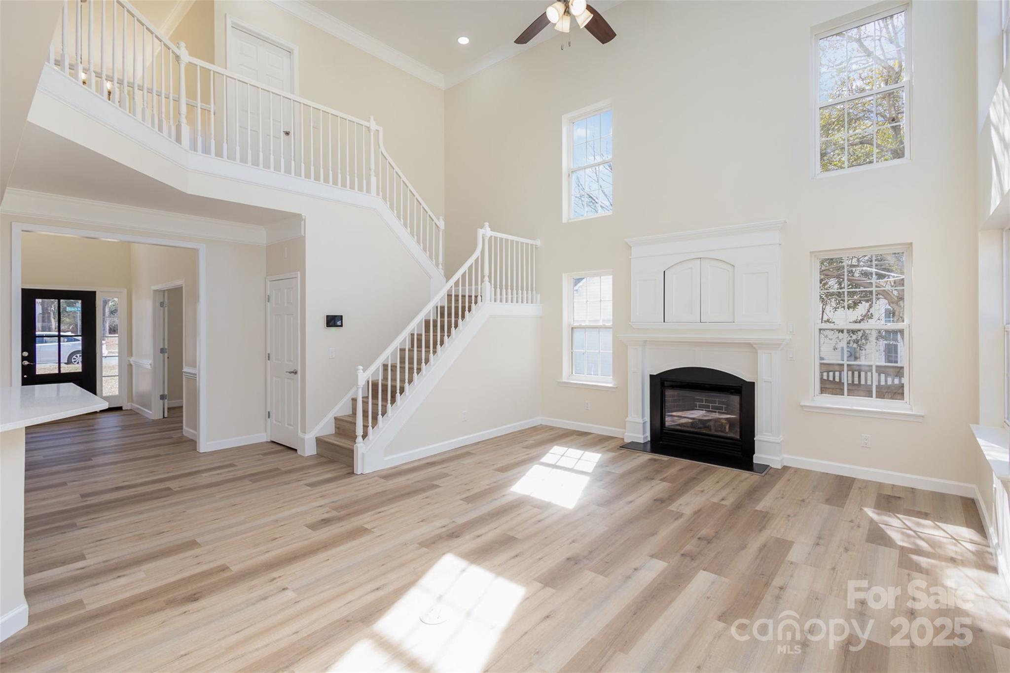 132 Elizabeth Hearth Road Mooresville, NC 28115 - Photo 9 of 40 a view of empty room with wooden floor and a fireplace