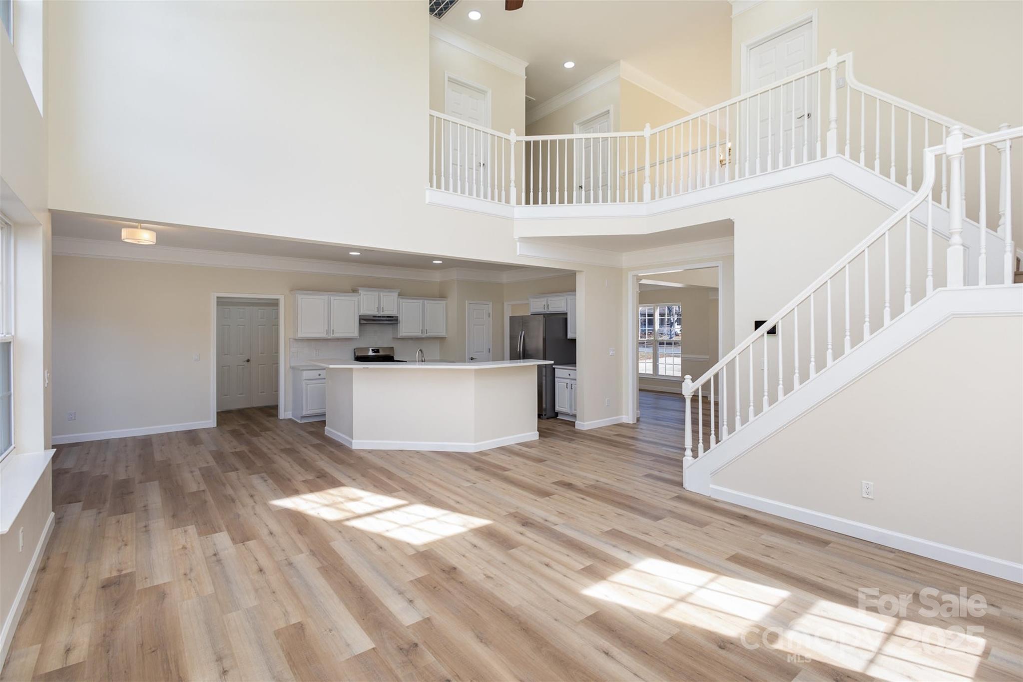 132 Elizabeth Hearth Road Mooresville, NC 28115 - Photo 10 of 40 a view of a hallway with wooden floor and entryway