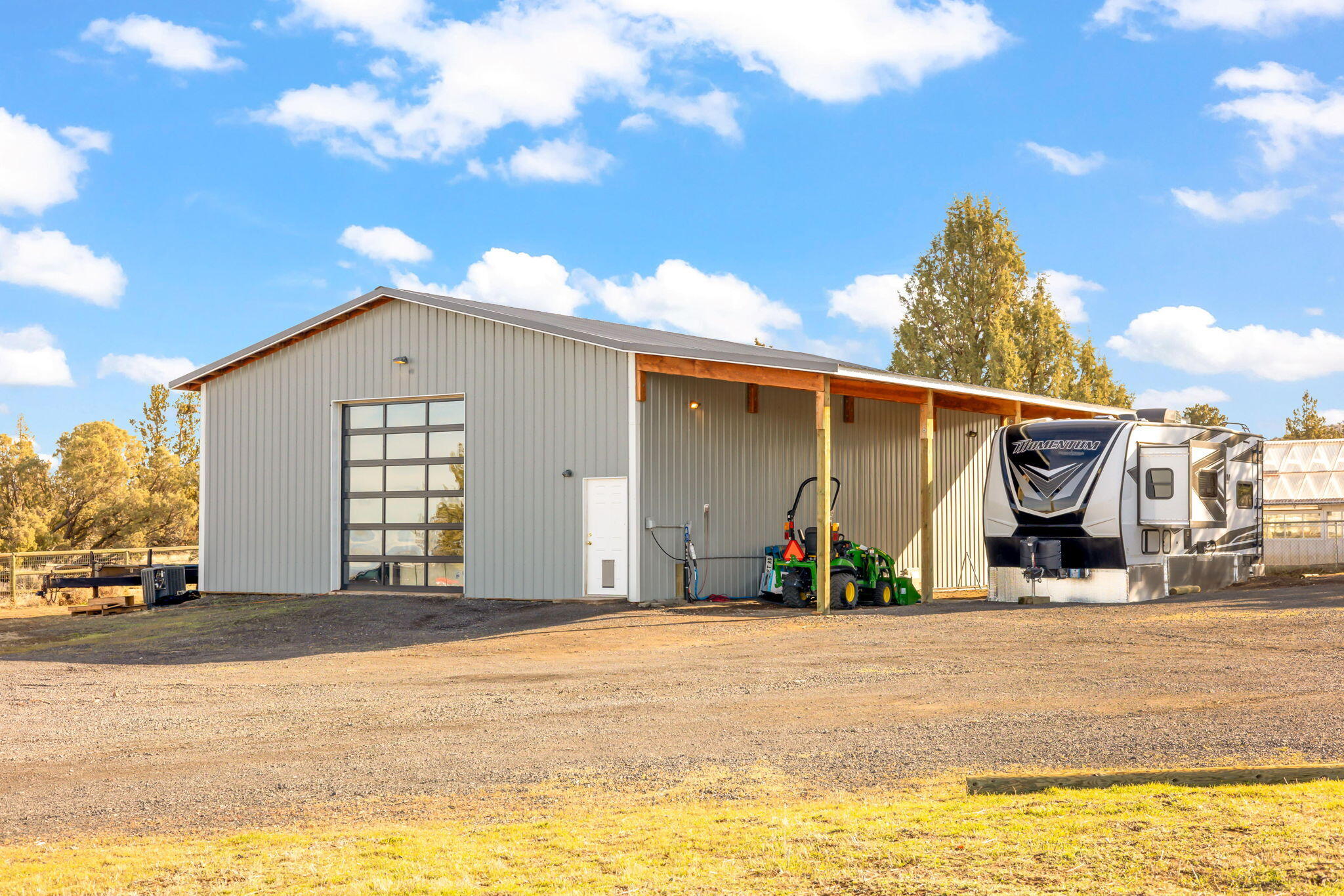 13680 Southwest Rust Bucket Road Powell Butte, OR 97753 - Photo 45 of 58 Shop with covered lean-to and stables in back.