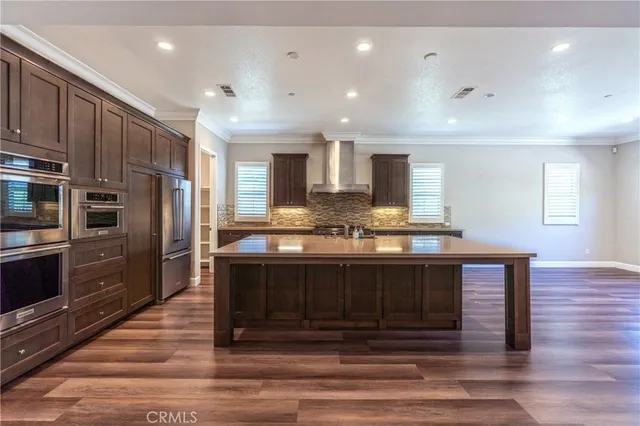 an empty room with wooden floor and a fireplace