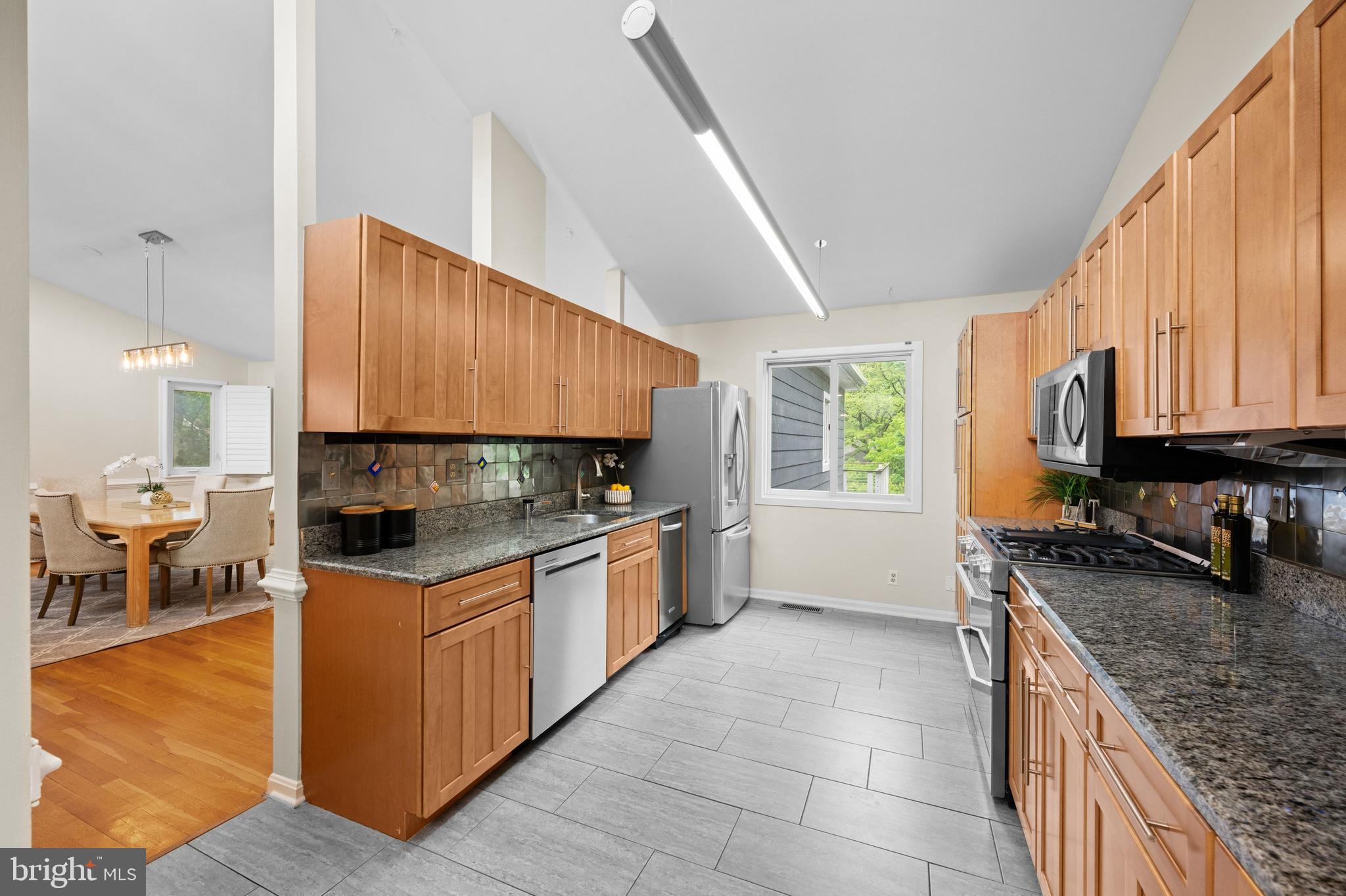 3529 Yuma Street Northwest Washington, DC 20008 - Photo 17 of 46 a kitchen with stainless steel appliances granite countertop a stove a sink and a microwave