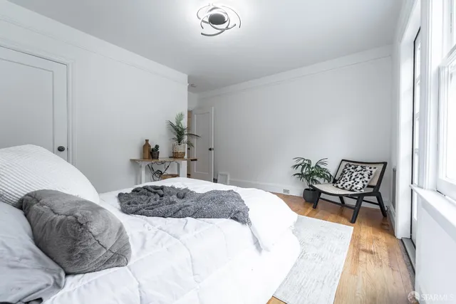 a bedroom with a bed and a chair