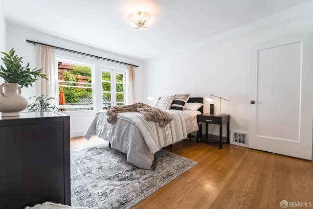 a spacious bedroom with a bed and large windows