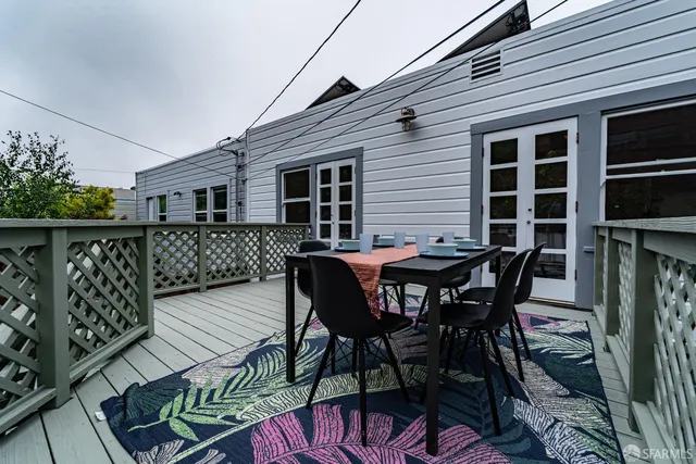 a view of a wooden chairs and table in the balcony