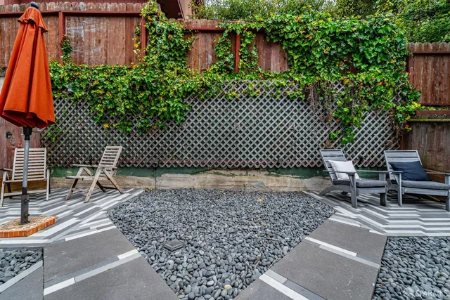 a view of a deck with table and chairs with wooden floor and plants