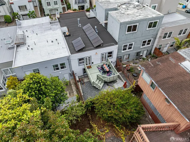 an aerial view of a house with garden space and street view