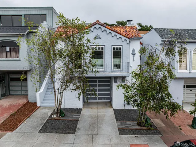 a front view of a house with a garden