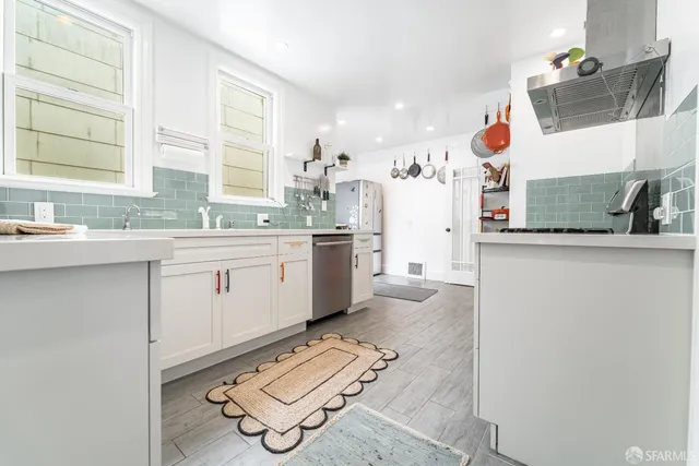 a kitchen with a sink appliances and cabinets