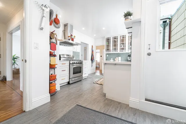 a kitchen with cabinets and wooden floor