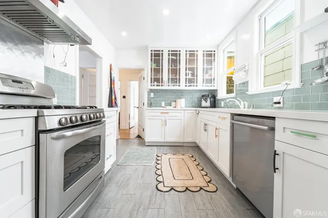 a kitchen with a sink stove and cabinets