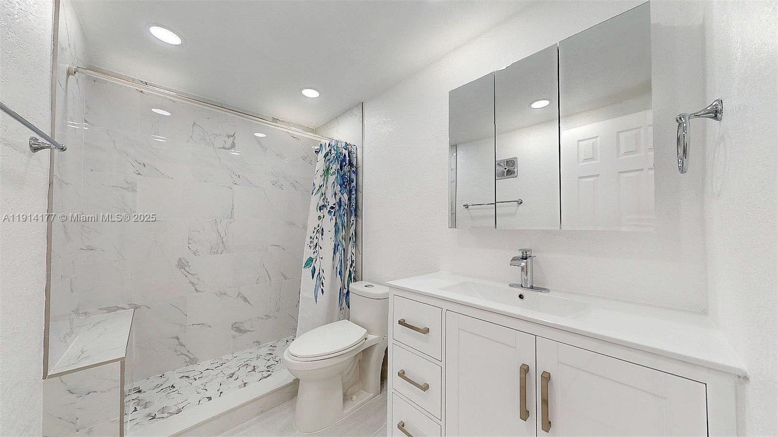 1201 Southwest 42nd Avenue, Unit 211 Miami, FL 33134 - Photo 14 of 19 a bathroom with a sink a toilet and shower