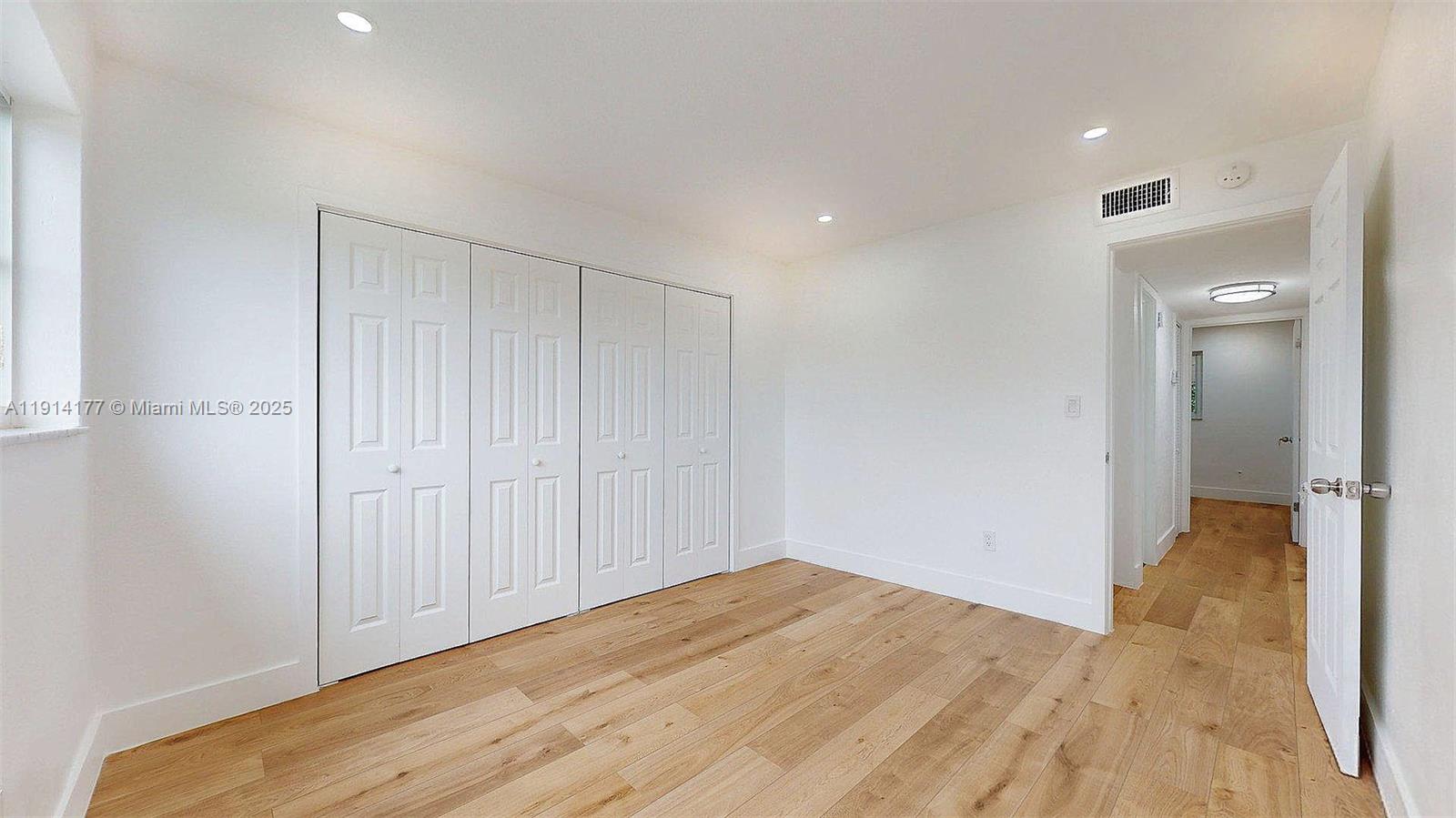 1201 Southwest 42nd Avenue, Unit 211 Miami, FL 33134 - Photo 15 of 19 a view of a room with wooden floor and natural light