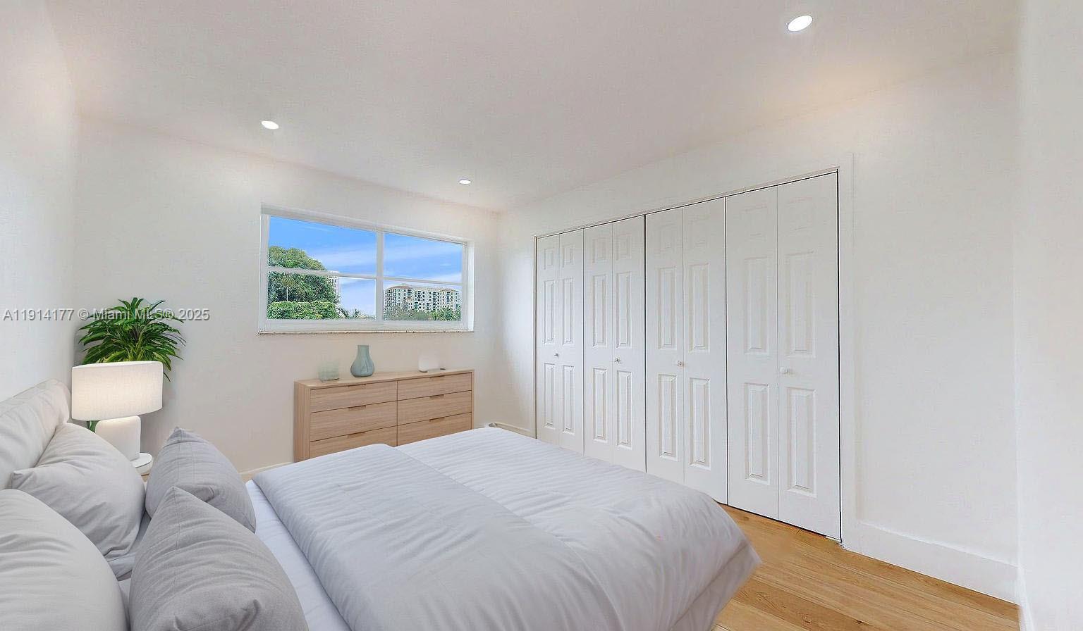 1201 Southwest 42nd Avenue, Unit 211 Miami, FL 33134 - Photo 17 of 19 a bedroom with a bed and a potted plant