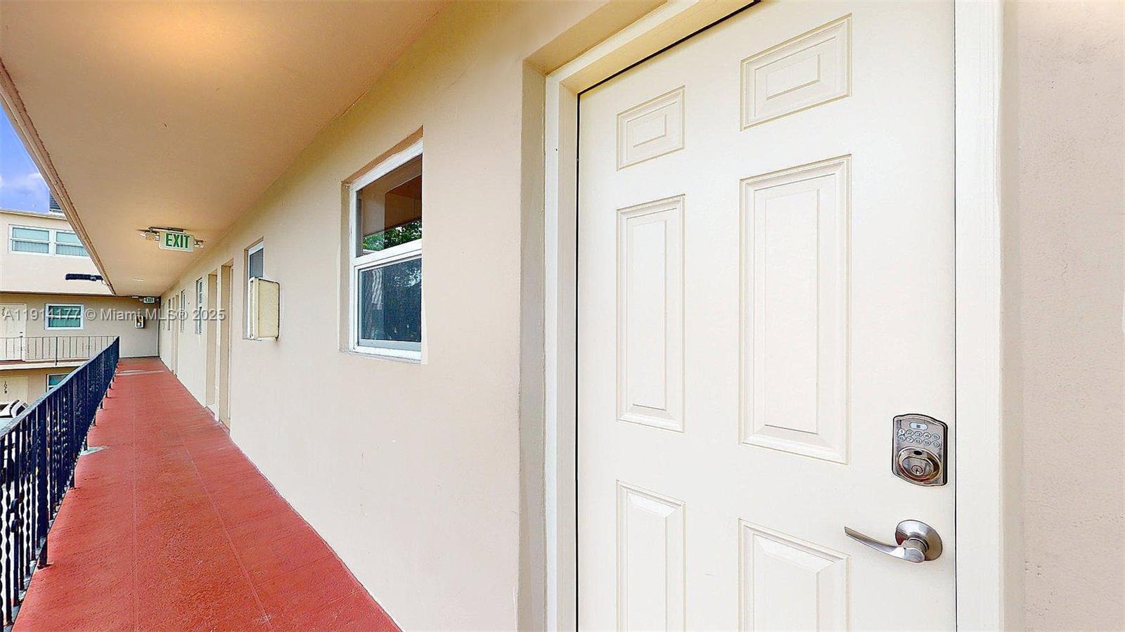 1201 Southwest 42nd Avenue, Unit 211 Miami, FL 33134 - Photo 3 of 19 a hallway with windows
