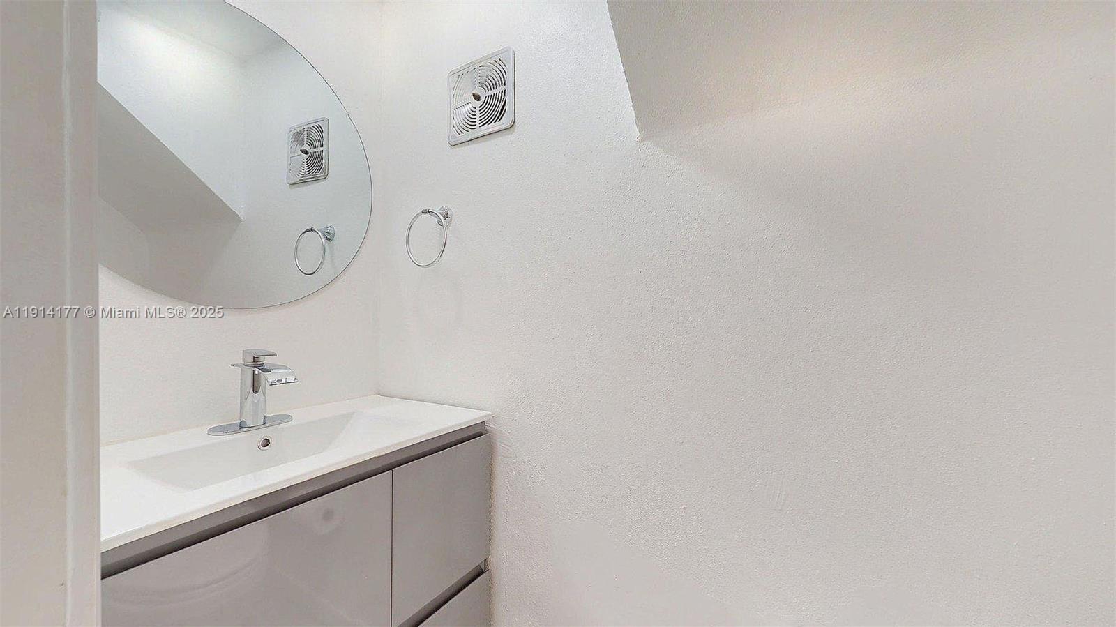 1201 Southwest 42nd Avenue, Unit 211 Miami, FL 33134 - Photo 7 of 19 a bathroom with a sink and a mirror