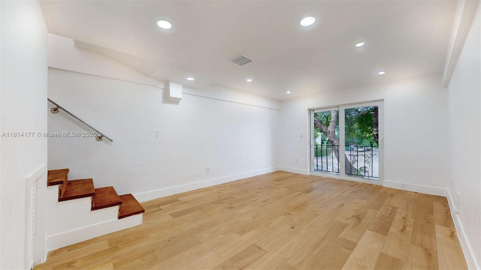1201 Southwest 42nd Avenue, Unit 211 Miami, FL 33134 - Photo 8 of 19 a bedroom with a bed and a large window