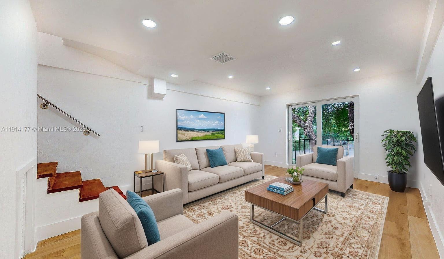 1201 Southwest 42nd Avenue, Unit 211 Miami, FL 33134 - Photo 9 of 19 a living room with furniture and a flat screen tv