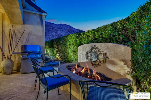a bedroom with a bed and large windows