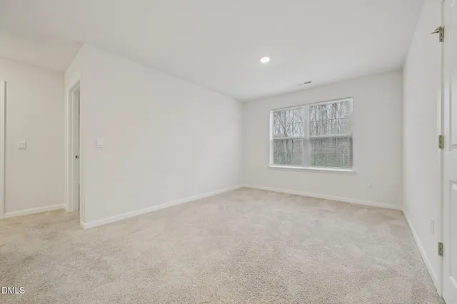 an empty room with a empty space and windows