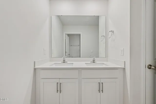 a bathroom with 2 sink and a mirror