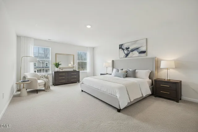 a spacious bedroom with a bed and window